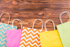 different-pattern-paper-bag-arranged-bottom-wooden-table